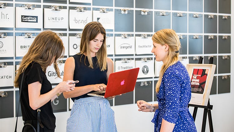 Female entrepreneurs creating a future board together