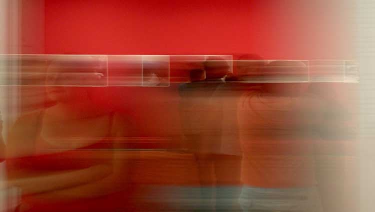 red picture with people walking in a museum, people are moving so they're hard to see