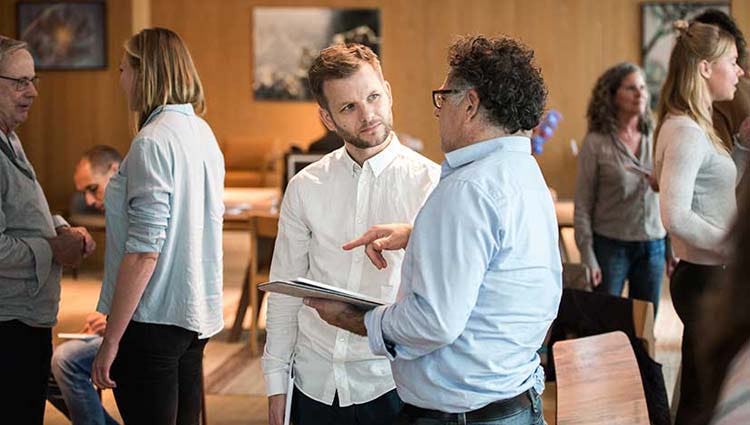 People discussing at an event in a coworking space