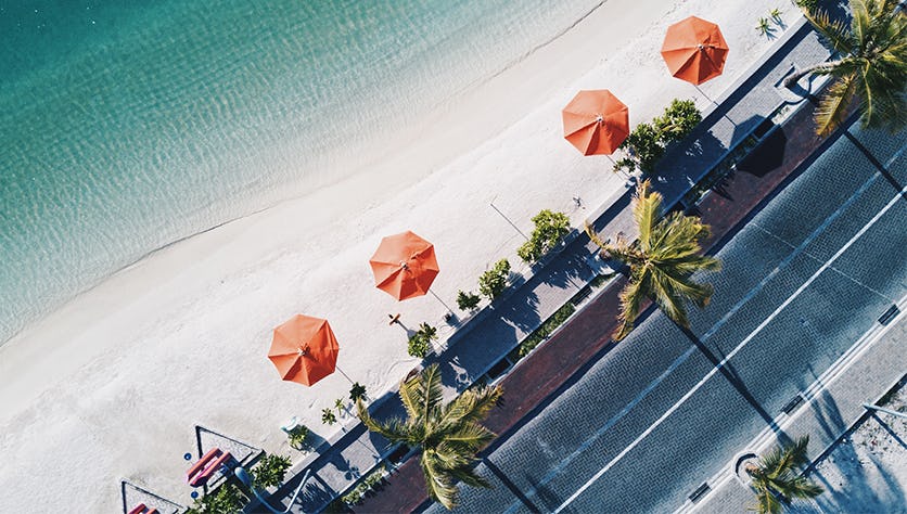 arial shot of beach with umbrellas