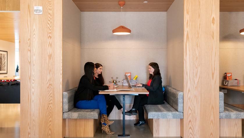 Women working in a coworking booth